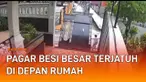 Terekam kamera CCTV sebuah pagar besi rumah terjatuh di depan jalan.