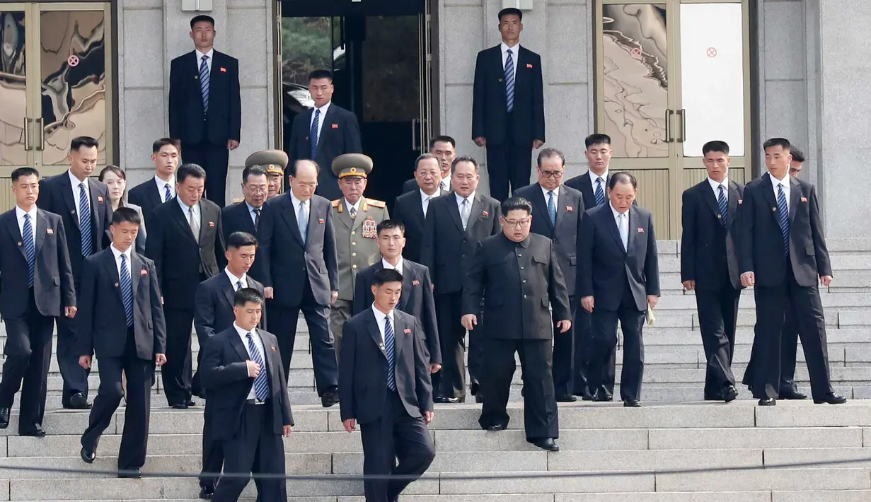Pemimpin Korea Utara Kim Jong-un dan delegasi mendapat pengawalan ketat saat akan bertemu Presiden Korea Selatan Moon Jae-in dalam KTT Korea Selatan-Korea Utara di zona demiliterisasi, Panmunjom, Korea Selatan, Jumat (27/4). (Korea Summit Press Pool/AP)