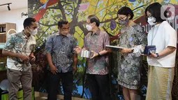 Ketua Pengurus Yayasan Dharma Bhakti Astra (YDBA) Sigit P. Kumala (tengah) melihat produk aneka loyang yang diproduksi UD Aneka Loyang dalam kegiatan syukuran HUT ke-42 YDBA di Galeri UKM YDBA, Jakarta (17/5/2022). UMKM tersebut telah berinovasi dalam proses produksi dengan mengoptimalkan mesin roll untuk memudahkan dan memastikan produk sesuai dengan standar quality, cost, delivery (QCD) yang dibutuhkan customer. (Liputan6.com/HO/YDBA)