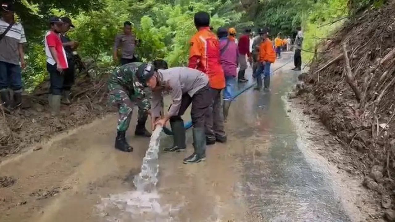Proses pembersihan material tanah longsor di jalan penghubung antar desa di Kecamatan Silo, Jember (Istimewa)