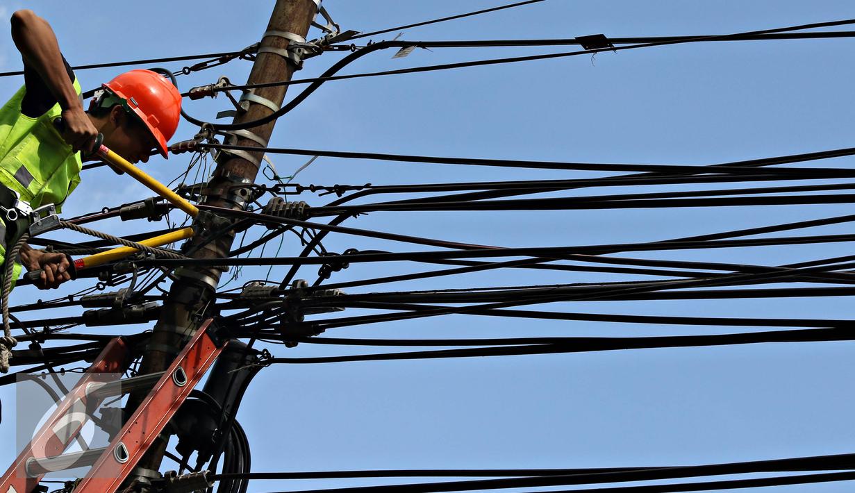Petugas PLN mengecek instalasi kabel di tiang listrik milik PLN, Jakarta (26/2). Mulai 28 Februari 2016, PLN berencana membongkar perangkat atau jaringan telematika yang memanfaatkan tiang listrik di Jakarta tanpa izin. (Liputan6.com/Immanuel Antonius)