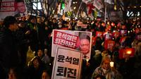 Keputusan Presiden Korea Selatan Yoon Suk Yeol terkait pemberlakuan darurat militer sontak mendorong ribuan orang untuk berkumpul di depan parlemen untuk melakukan protes. (Philip FONG/AFP)