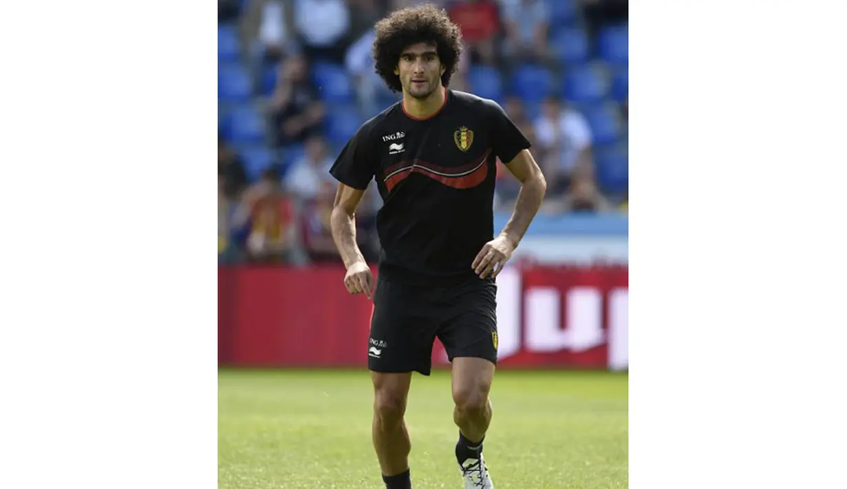 Pemain bernama lengkap Marouane Fellaini-Bakkioui merupakan seorang pemain sepak bola Belgia yang biasa bermain pada posisi gelandang. Saat ini bermain untuk klub Manchester United. (AFP PHOTO/John Thys)