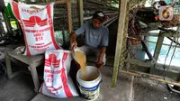 Peternak menyiapkan pakan ayam petelur di Gunung Sindur, Bogor, Jawa Barat, Selasa (6/6/2023). (merdeka.com/Arie Basuki)