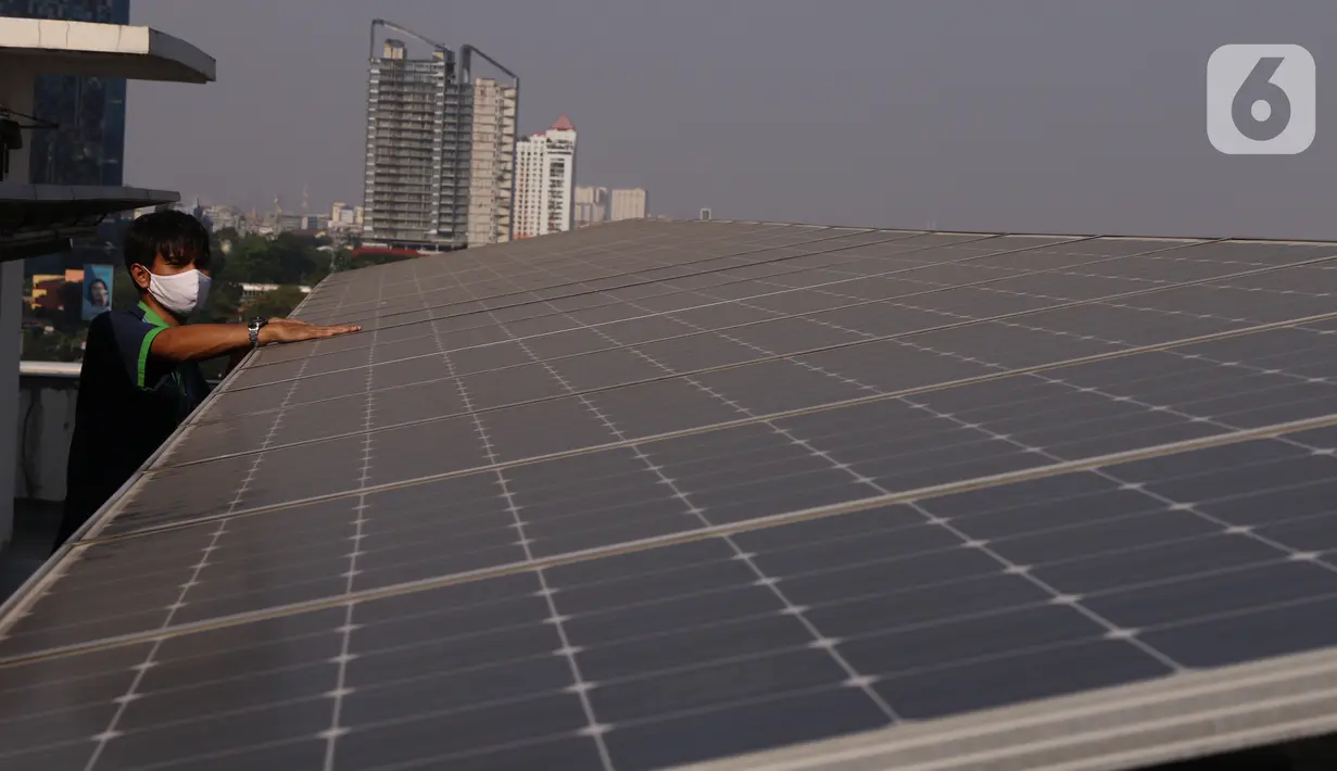 Pekerja melakukan pengecekan panel surya di atas gedung di kawasan Jakarta, Senin (31/8/2020). Pemerintah tengah menyiapkan peraturan presiden terkait energi baru terbarukan dan konservasi energi agar target 23 persen bauran energi di Indonesia bisa tercapai pada 2045. (Liputan6.com/Angga Yuniar)