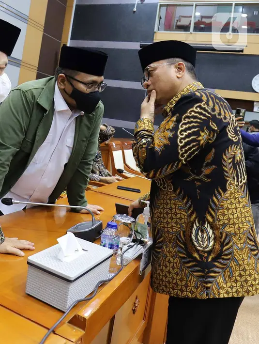 Menteri Agama Yaqut Cholil Qoumas berbincang dengan Ketua Komisi VIII DPR Yandri Susanto sebelum rapat kerja di Jakarta, Rabu (13/4/2022). Kementerian Agama bersama Komisi VIII menyepakati Biaya Penyelenggaraan Ibadah Haji Tahun 1443 H/2022 sebesar Rp39,8 juta per orang. (Liputan6.com/Angga Yuniar)