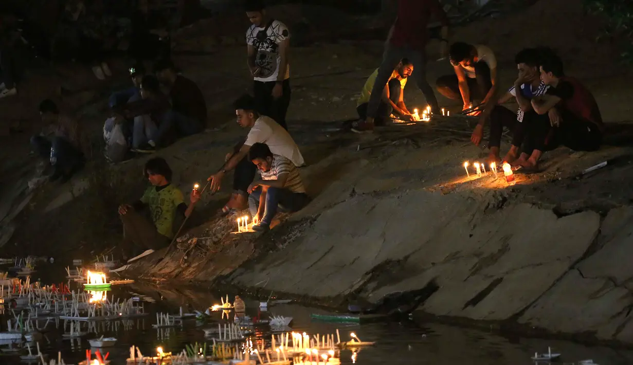 Para peziarah menyalakan lilin di luar kuil Imam al-Mahdi selama upacara Shaabaniya untuk memperingati kelahiran Imam, tokoh paling suci untuk Muslim Syiah, di kota Karbala, Irak tengah, (2/5). (AFP Photo/Mohammad Sawaf)