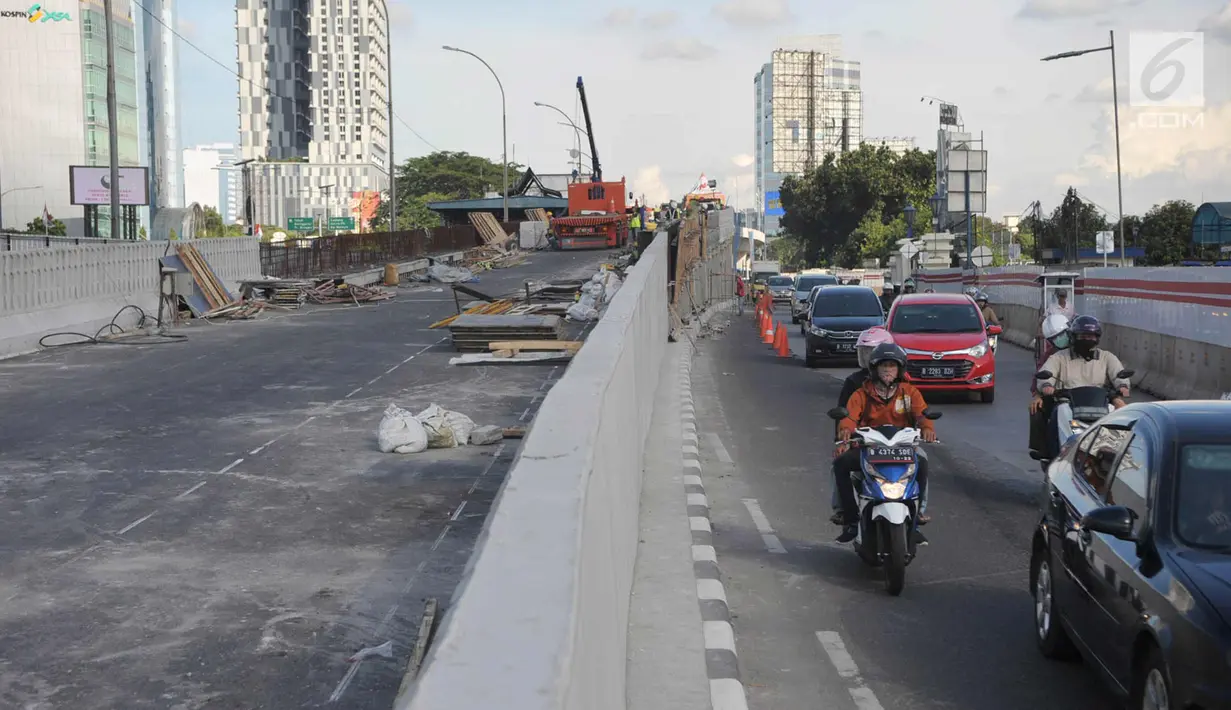 Kendaraan melintas di samping pembangunan proyek flyover Pancoran di Jakarta, Selasa (9/1). Proyek untuk mengurai kemacetan di Ibukota tersebut ditargetkan mulai beroperasi pada pertengahan bulan Januari 2017. (Liputan6.com/Immanuel Antonius)