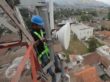 Teknisi XL melakukan perawatan atas perangkat BTS 4G di atas menara di kawasan Lembang, Bandung, (2/11/2015). Proses refarming atau penataan ulang frekuensi 1800Mhz telah selesai untuk wilayah Kota Bandung dan sekitarnya. (Liputan6.com/Yudha Gunawan)