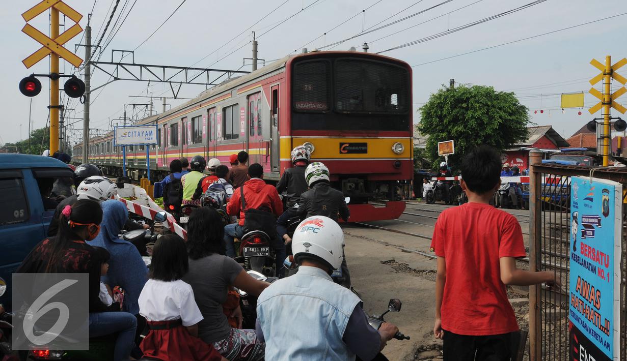Kereta Commuter Line melintasi perlintasan dekat Stasiun Citayam, Bogor, Rabu (25/11/2015). Sebelumnya, Selasa (24/11) tanah di sekitar rel KM 38 dan 39 mengalami longsor. (Liputan6.com/Helmi Fithriansyah)