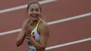 Ekspresi Atlet cantik asal Jerman, Gina Luckenkemper usai menjuarai 100m putri pada ajang IAAF World Championships 2017 di London Stadium, (5/8/2017). (AFP/Adrian Dennis)