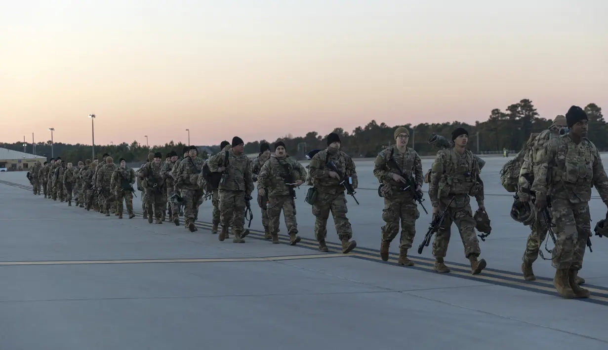 Anggota Divisi Lintas Udara ke-82 Angkatan Darat AS berjalan di landasan Lapangan Paus menjelang penempatan ke Polandia dari Fort Bragg, AS, 14 Februari 2022. Mereka termasuk di antara tentara AS yang dikirim untuk NATO karena khawatir Rusia akan menyerang Ukraina. (AP Photo/Nathan Posner)