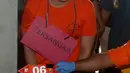 Tersangka Altaf yang berkacamata terlihat tertunduk lesu saat mengenakan baju tahanan berwarna oranye dengan tangan terborgol. (merdeka.com/Arie Basuki)