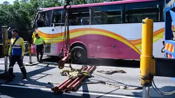 Sejumlah petugas mengevakuasi sebuah bus setelah bertabrakan dengan taksi di Hong Kong (30/11). Lima orang tewas dan 32 luka-luka setelah akibat kecelakaan tersebut. (AFP Photo/Anthony Wallace)