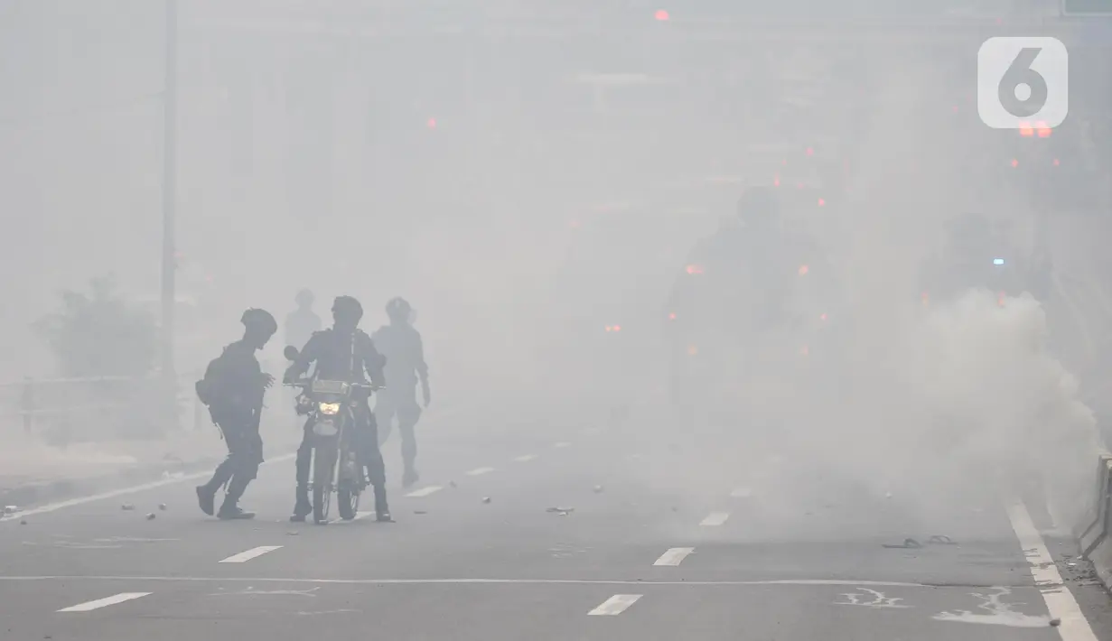 Petugas kepolisian menembakkan gas air mata saat berupaya membubarkan massa yang menggelar aksi di depan Gedung DPR RI, Jakarta, Senin (11/4/2022). Situasi mulai memanas akibat sejumlah pengunjuk rasa melempari petugas dengan berbagai benda. (merdeka.com/Iqbal S Nugroho)