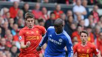 Kapten Liverpool Steven Gerrard terpeleset sehingga striker Chelsea Demba Ba mencetak gol pada laga di Anfield, April 2014. Liverpool tumbang 0-2 dan gagal juara Liga Inggris. (AFP/Andrew Yates)