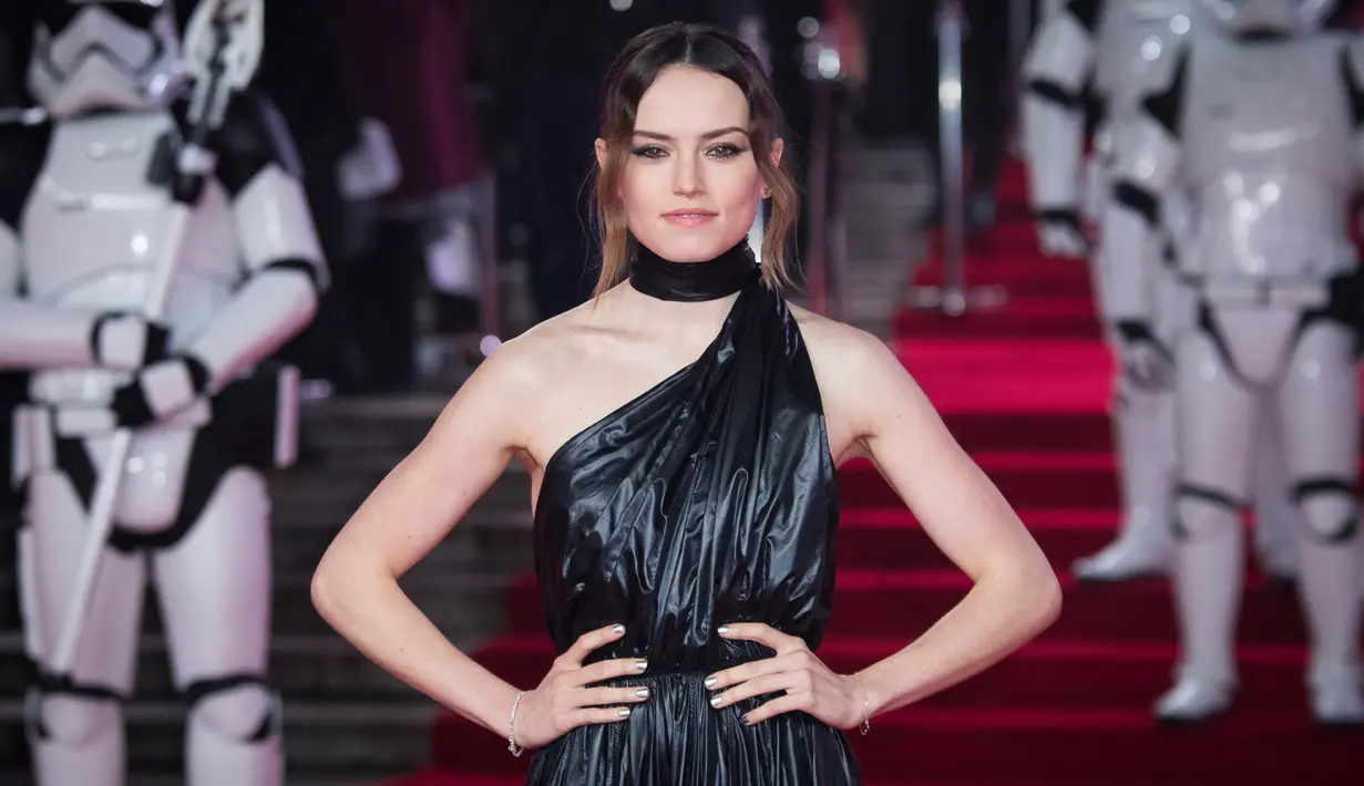 Aktris Daisy Ridley berpose setibanya pada pemutaran perdana film Star Wars: The Last Jedi di Royal Albert Hall, London, Selasa (12/12). Ridley mengenakan gaun rancangan Raf Simons untuk Calvin Klein dengan material tak biasa (Vianney Le Caer/Invision/AP)