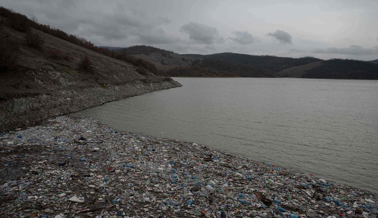 Kondisi ini diperparah oleh hujan deras dan genangan banjir yang membawa sampah dari pemukiman sekitar ke dalam waduk. Tampak dala foto, ceceran botol plastik dan sampah lainnya, yang hanyut terbawa hujan, mengapung di sepanjang Waduk Badovc di dekat Pristina, Kosovo pada Rabu 4 Februari 2026.