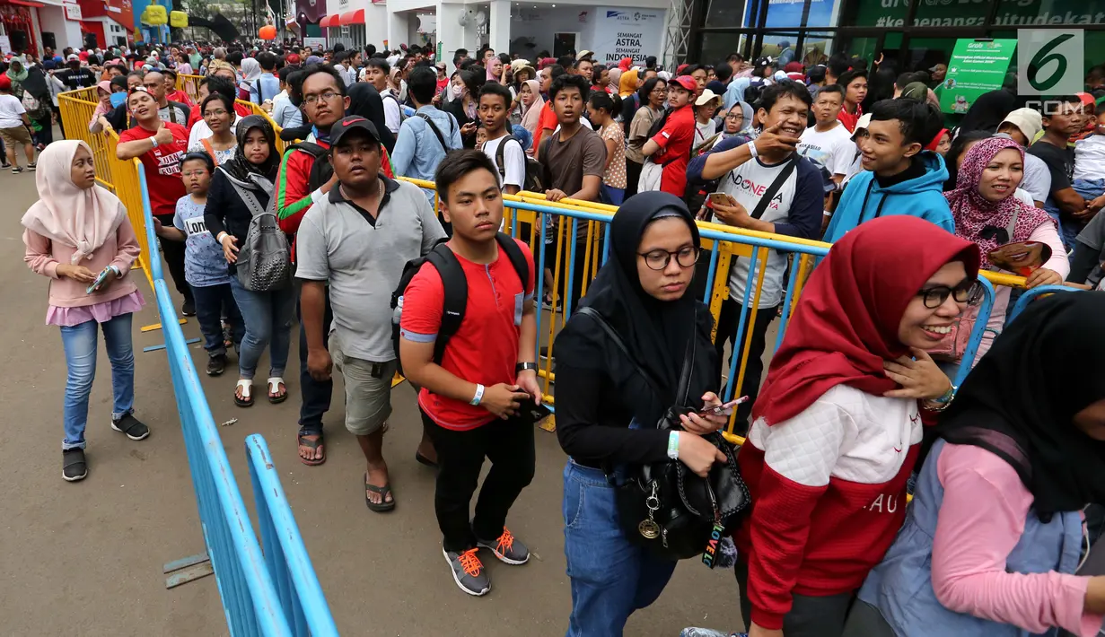 Pengunjung antre menuju Merchandise Superstore jelang Closing Ceremony Asian Games 2018 di kawasan Gelora Bung Karno, Jakarta, Minggu (2/9). Mereka rela antre berjam-jam sebelum toko dibuka. (Liputan6.com/Fery Pradolo)