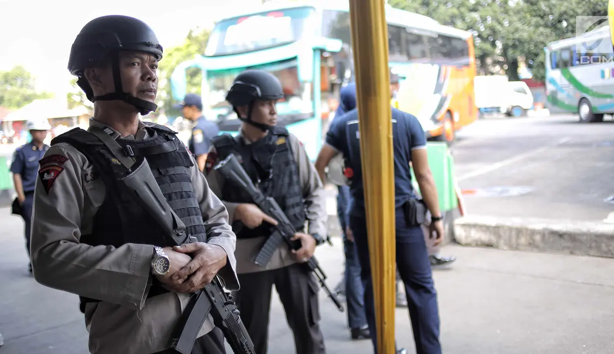 Pasukan Brimob Polda Metro Jaya bersenjata lengkap patroli di Terminal Kampung Rambutan, Jakarta, Selasa (19/6). Penjagaan dilakukan untuk memberi rasa aman kepada pemudik pada arus balik Lebaran 2018. (Liputan6.com/Faizal Fanani)