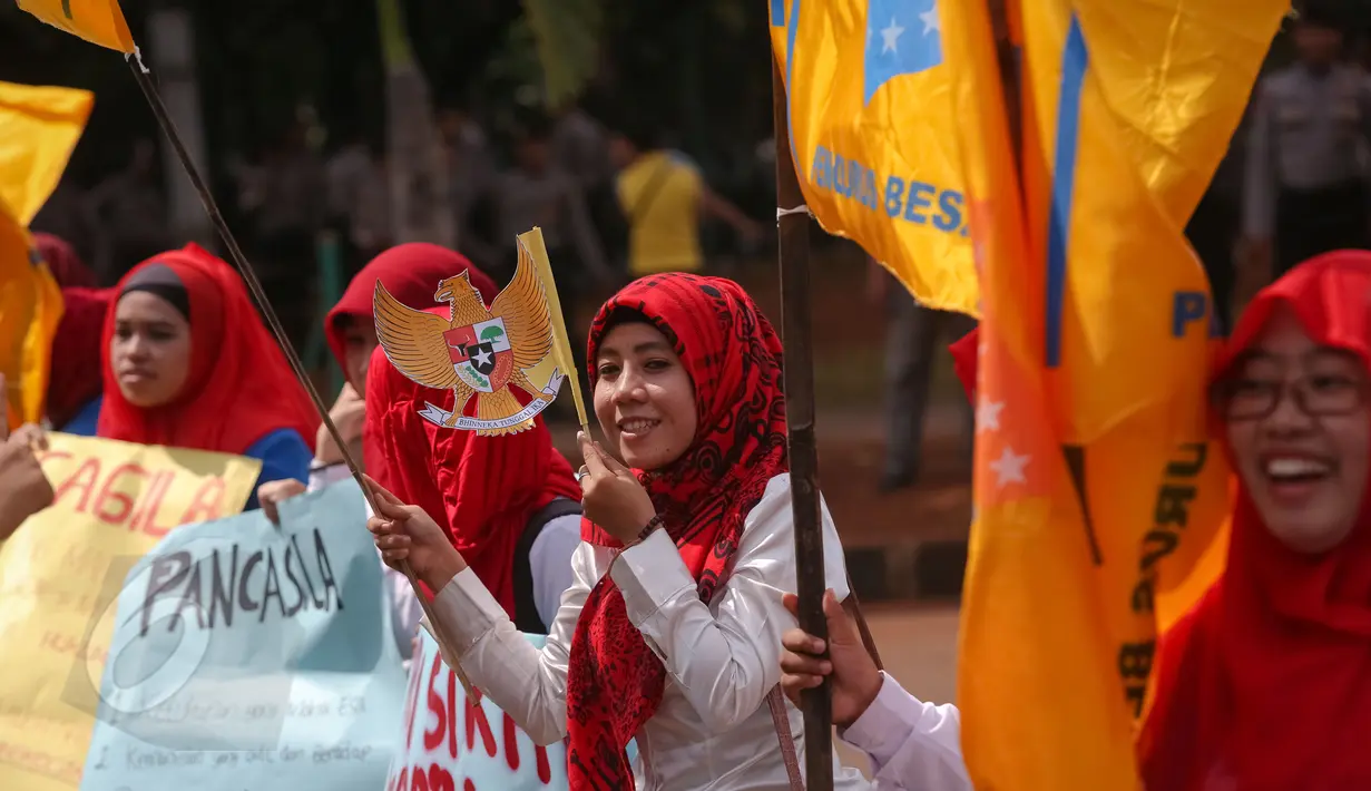 Aktivis dari Pergerakan Mahasiswa Islam Indonesia Puteri memegang bendera Garuda Indonesia saat menggelar aksi memperingati Hari Kelahiran Pancasila, di depan Istana Merdeka, Jakarta, Senin (1/6/2015). (Liputan6.com/Faizal Fanani)