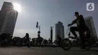 Warga berolahraga di area Car Free Day (CFD) kawasan MH Thamrin, Jakarta, Minggu (21/6/2020). Hari ini adalah kali pertama digelarnya CFD Jakarta di sepanjang Jalan Sudirman - Thmarin saat Pembatasan Sosial Berskala Besar (PSBB) Masa Transisi. (Liputan6.com/Johan Tallo)