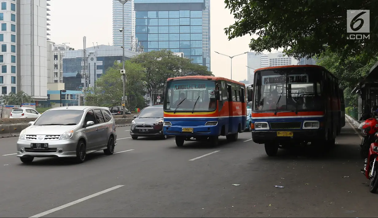 Bus Metromini melintas di Jalan Jenderal Sudirman, Jakarta, Rabu (4/7). Larangan bagi Kopaja dan Metromini melintasi jalan protokol selama Asian Games untuk mengurangi kemacetan dan polusi di jalan protokol. (Liputan6.com/Arya Manggala)
