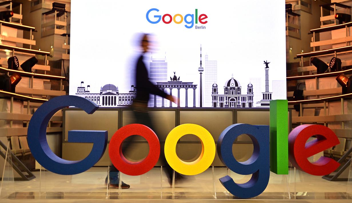 Seorang teknisi melewati logo mesin pencari internet, Google, pada hari pembukaan kantor baru di Berlin, Selasa (22/1). Google kembali membuka kantor cabang yang baru di ibu kota Jerman tersebut. (Photo by Tobias SCHWARZ / AFP)