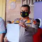 Kapolresta Pekanbaru Komisaris Besar Nandang Mu'min Wijaya memperlihatkan barang bukti surat bebas Covid-19 palsu. (Liputan6.com/M Syukur)