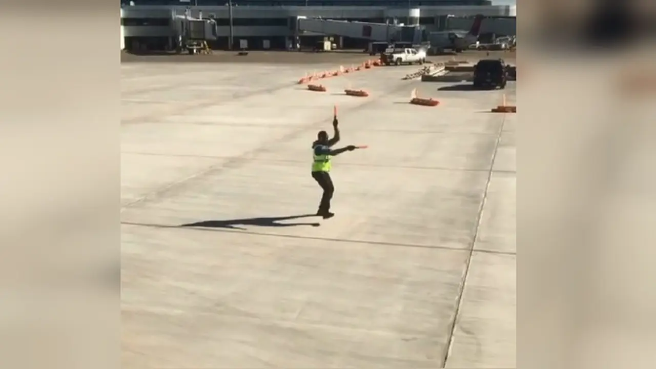 Aksi seorang ground marshall atau petugas parkir pesawat yang membuat heboh netizen (Facebook/Terry McBride)