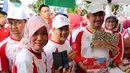 Jajaran Direksi Telkom Indonesia dan Kementerian BUMN berbelanja produk kerajinan di UKM Binaan Telkom menggunakan aplikasi LinkAja pada acara Jalan Sehat BUMN HUT ke-74 RI di Tarakan, Sabtu (17/8/2019). (Liputan6.com/HO/Ady)