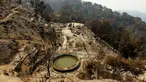Sebuah rumah hancur setelah hangus terbakar akibat kebakaran hutan di kawasan Palo Colorado, Big Sur, California, Amerika Serikat, AS, (1/7). Seluas 8.000 hektare hutan terbakar akibat musibah tersebut. (REUTERS/Michael Fiala)