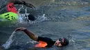 Dia berenang sejauh sekitar 100 meter, bergantian antara gaya bebas dan gaya dada. (JULIEN DE ROSA / AFP)