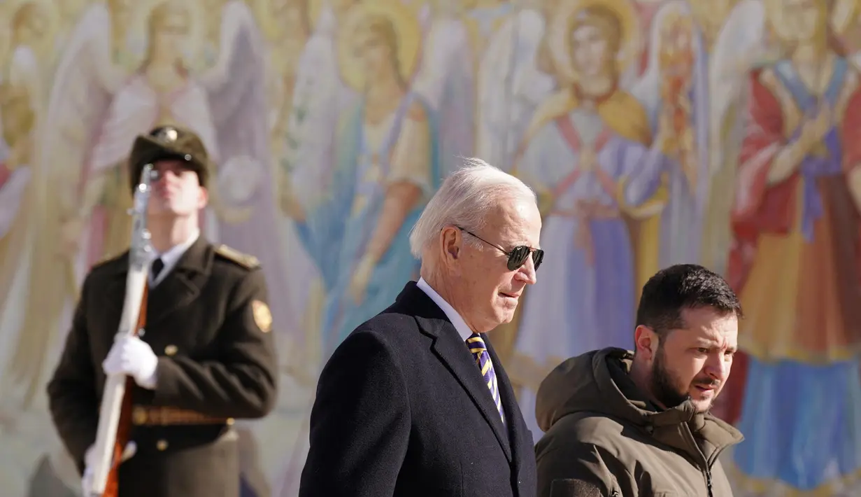 Presiden Ukraina Volodymyr Zelensky (kanan) bersama Presiden AS Joe Biden (tengah) saat setelah tiba di Kyiv, Ukraina pada 20 Februari 2023. Zelensky menyambut gembira kunjungan Presiden AS Joe Biden. Kedua presiden tersebut juga mengunjungi Wall of Remembrance of the Fallen for Ukraine di Kyiv. (Dimitar DILKOFF/AFP)