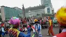 Aksi badut yang tergabung dalam Aku Badut Indonesia menghibur masyarakat saat car free day di Bunderan HI, Jakarta, Minggu (9/12). Aksi tersebut bentuk kampanye positif bertujuan mengajak masyarakat peduli terhadap sesama. (Liputan6.com/Faizal Fanani)
