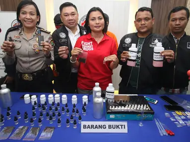 Kasat Narkoba Polres Jakarta Selatan Kompol Vivick Tjangkung menunjukkan tersangka beserta barang bukti kasus cairan rokok elektrik berbahan ganja di Mapolres Jakarta Selatan, Selasa (21/3). (Liputan6.com/Immanuel Antonius)