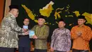  Ketua Fraksi PPP MPR Irgan Khairul Mafis saat memberikan buku laporan F PPP "Lima Tahun Membumikan Konstitusi" kepada Ketua MUI Din Syamsuddin, Jakarta, Selasa (23/12/2014). (Liputan6.com /Andrian M Tunay)