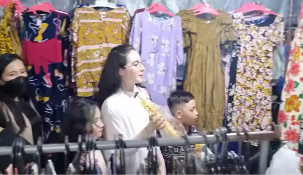 Sebelum pulang, mampir ke kios sendal hingga daster. Ia membeli sandal dan juga daster untuk ART yang bersamanya. Menariknya saat memilih sandal, Arumi sempat mengajak dua asistennya untuk membeli sandal kembaran. [Youtube/Arumi Bachsin]