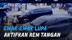 Petugas parkir tampak panik dan berusaha menahan laju mobil agar tak terjadi kecelakaan.