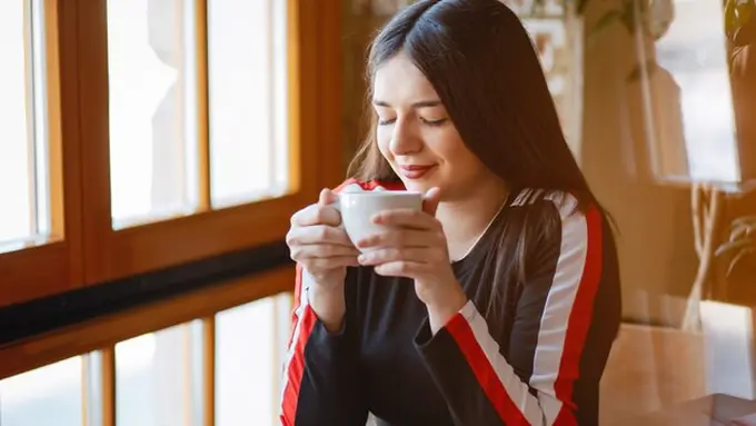 Seorang perempuan sedang me time di sebuah cafe (Foto Dok: Freepik/prostooleh)