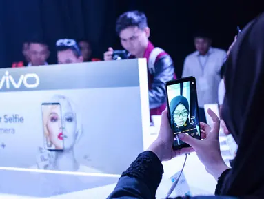 Pengunjung mencoba fitur selfie pada smartphone Vivo V7 Plus dalam grand launching VIVO V7 Plus, Jakarta, Kamis (28/9). VIVO V7 Plus memiliki kamera depan 24 megapixel dan full view display. (Liputan6.com/Faizal Fanani)