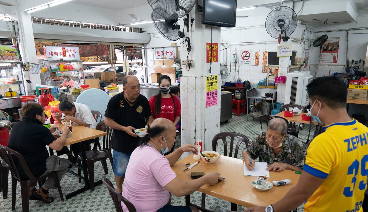 Pelanggan sarapan di sebuah restoran lokal di Kuala Lumpur, Malaysia, Senin, (4/5/2020). Malaysia sejak lockdown sejatinya baru akan berakir pekan depan. Perdana Menteri Muhyiddin Yassin berusaha untuk menyeimbangkan antara membatasi virus dan menghidupkan kembali ekonomi. (AP/Vincent Thian)