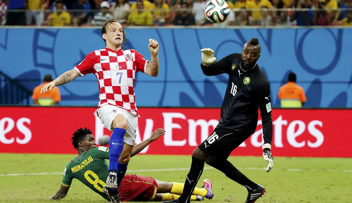 Gelandang Kroasia, Ivan Rakitic (tengah) mencoba mengecoh dua pemain belakang Kamerun saat berlaga di babak penyisihan Piala Dunia 2014 Grup A di Stadion Amazonia, Manaus, Brasil, (19/6/2014). (REUTERS/Yves Herman) 