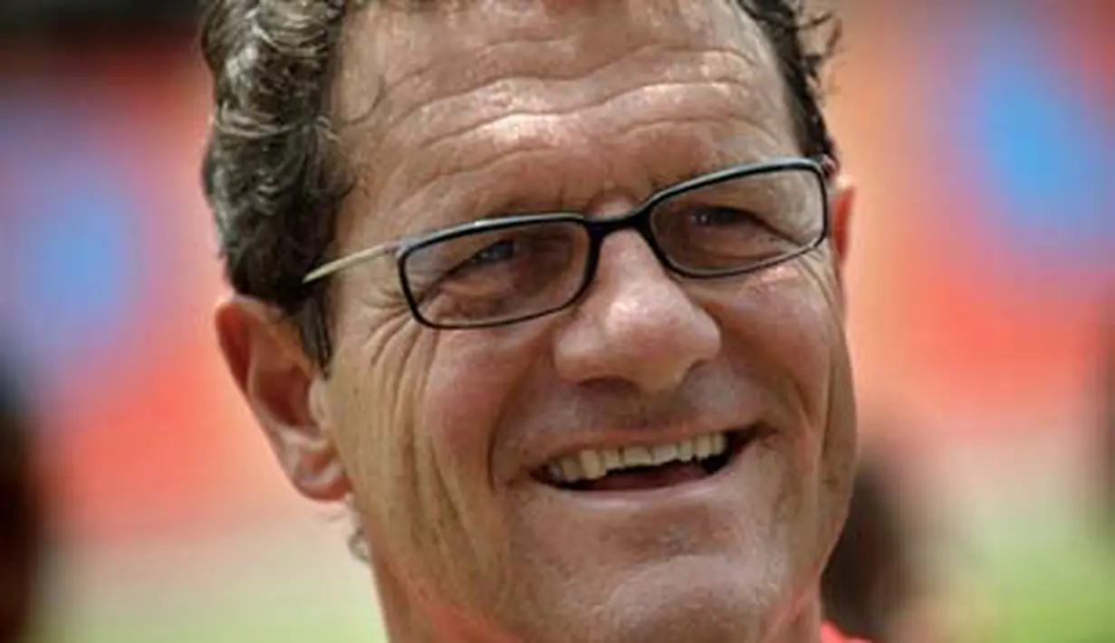 England coach Fabio Capello gestures as he coaches children during a football clinic at Rajamangala Stadium in Bangkok on July 26, 2008. Capello will hold clinics/ NICOLAS ASFOURI 