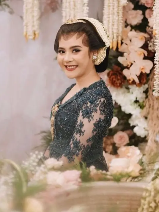 Wajahnya pun dirias glamor dengan lipstik merah matte bold dengan riasan mata boldnya. Dengan gaya rambut sanggul klasik dihiasi ronce melati dan paesnya.  [@ambarpaes_jakarta]