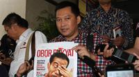 Pemimpin Redaksi Tabloid Obor Rakyat Setyardi Budiyono memegang tabloid Obor Rakyat  seusai menjalani pemeriksaan di Bareskrim Mabes Polri, Jakarta, Senin (23/6). (ANTARA FOTO/Reno Esnir)