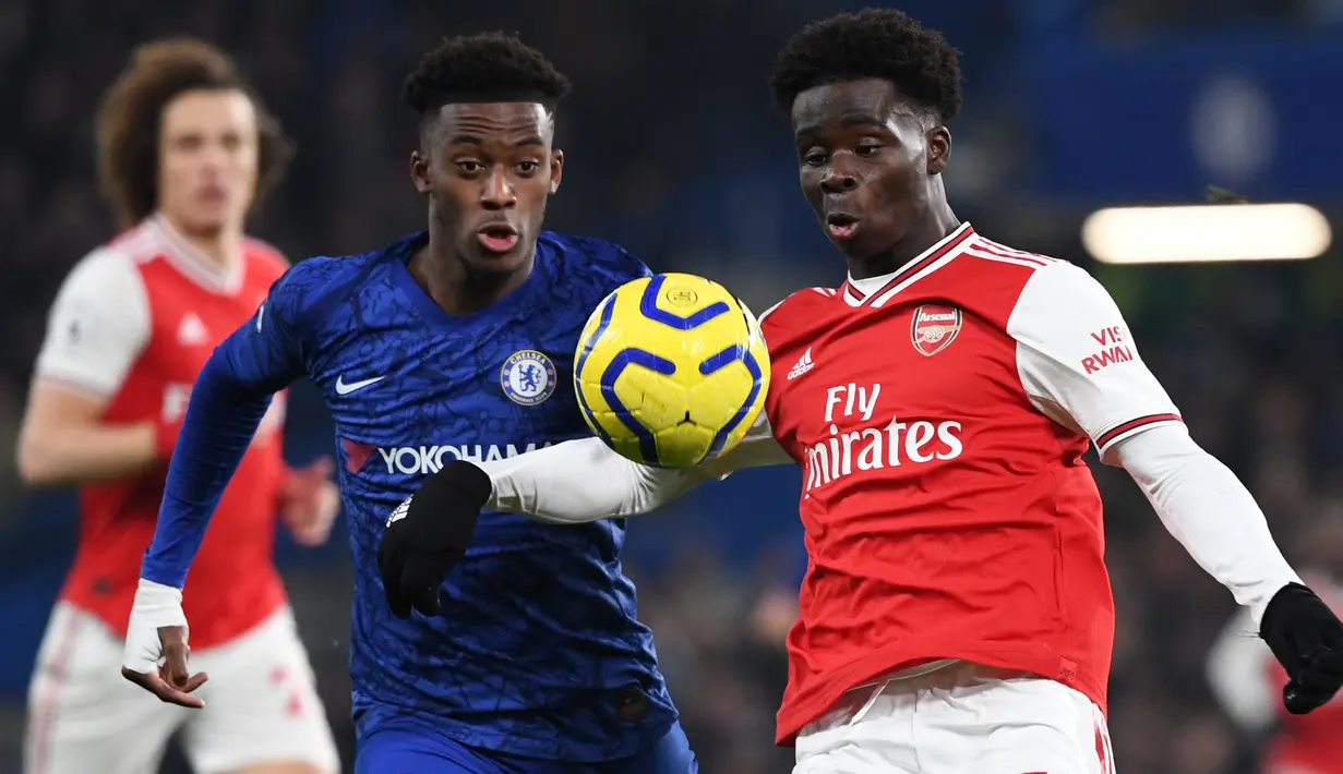 Gelandang Chelsea, Callum Hudson-Odoi berebut bola dengan striker  Arsenal, Bukayo Saka pada lanjutan pertandingan Liga Inggris di Stamford Bridge, Selasa (21/1/2020). Chelsea gagal memetik hasil maksimal usai ditahan Arsenal dengan skor 2-2. (DANIEL LEAL-OLIVAS / AFP)