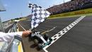 Pebalap Mercedes, Lewis Hamilton, saat finis pertama dalam balapan F1 GP Hungaria di Sirkuit Hungaroring, Budapest, Minggu (24/7/2016). (AFP/Andrej Isakovic)