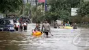 Hujan yang mengguyur Jakarta sejak Minggu (8/2) lalu, mengakibatkan tingginya genangan air di kawasan Kelapa Gading. Tampak Petugas menyeberangkan warga dengan perahu karet, Jakarta, Selasa (10/2/2015). (Liputan6.com/Faizal Fanani)