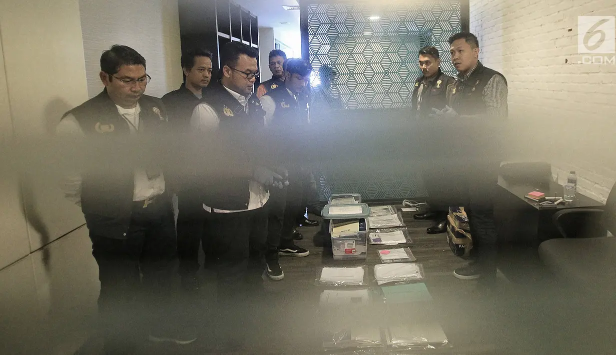 Satgas Antimafia Bola Polri menunjukan barang bukti hasil penggeledahan dari kantor PSSI di Fx  Tower, Jakarta, Rabu (30/1). Dokumen-dokumen tersebut berkaitan dengan persepakbolaan dan anggaran tahun 2017 dan 2018. (Liputan6.com/Faizal Fanani)